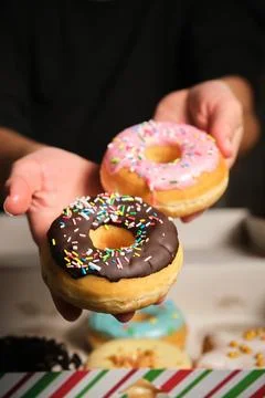 Two donuts in a woman's hand Foto stock
