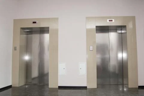 Two doors of elevators in modern business building. Stock Photos