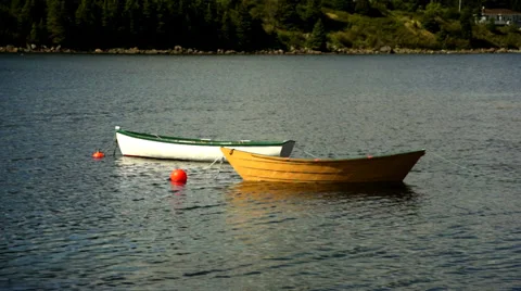 Two Dories Docked in Water Stock Footage 27549260