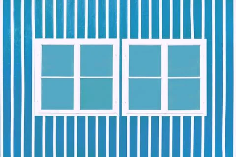 Two double white windows on a blue wall with white slats. Stock Photos