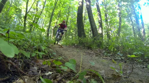 Two downhill cyclists passing fast by the camera Stock Footage 55952809