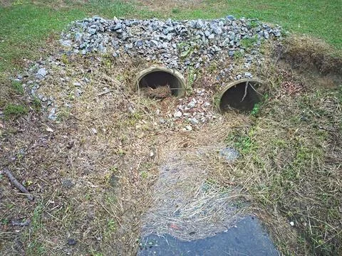 Two Drainage Culverts in a Ditch Stock Photos