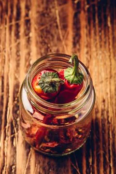 Two dried red chili peppers in jar Stock Photos