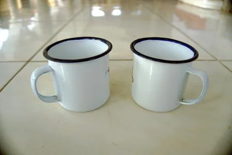 Two drinking cups are lined up on the floor Stock Photos