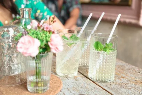 Two drinks with mint and straws in glasses Stock Photos