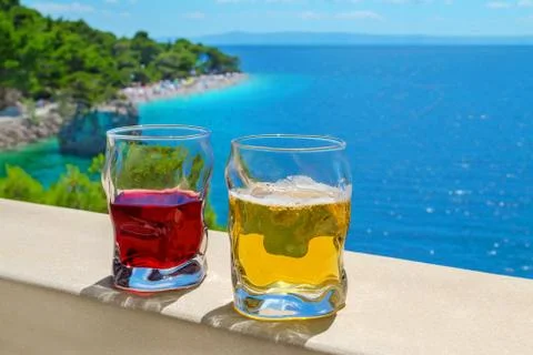 Two drinks with view of beach punta rata in croatia, brela Stock Photos