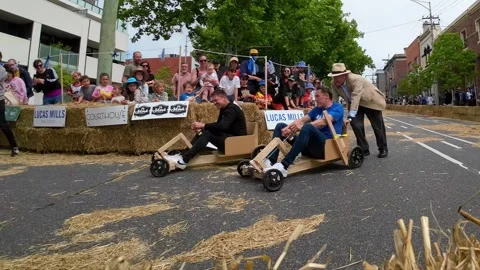 Two drivers race downhill at Queensberry Cup Billycart Race Stock Footage 319508741