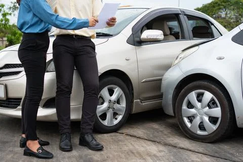 Two Drivers using a smartphone to exchange phone numbers and social media aft Foto stock