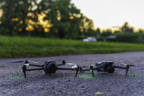 Two drones on the ground at sunset Stock Photos