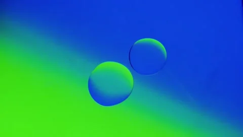 Two drops connect together on a blue-green gradient background. 스톡 동영상 303059637