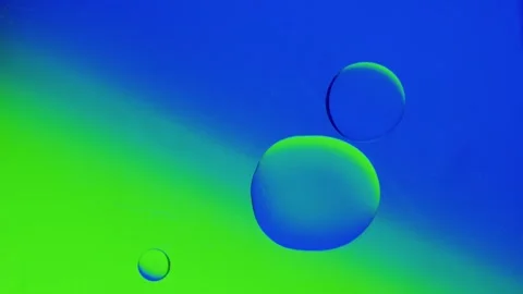 Two drops connect together on a blue-green gradient background. Видео 303059647