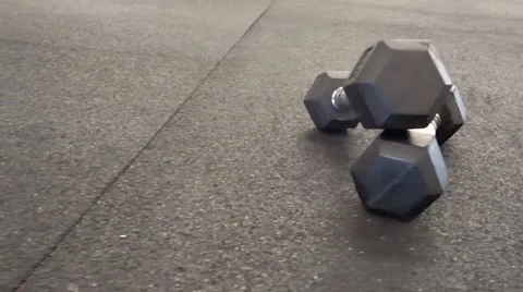 Two dumbbells on athletic flooring Stock Footage 54372313