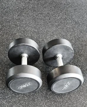 Two dumbbells on the floor Stock Photos