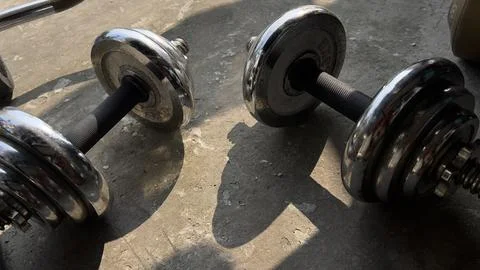 Two Dumbbells on the floor Stock Photos