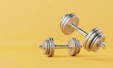 Two dumbbells on isolated yellow background. Fitness accessories and sport .. Stock Photos