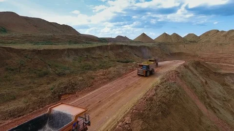 Two dump trucks carry ore from the quarry. Panorama of the mine. Barkhan sands Video stock 75041693