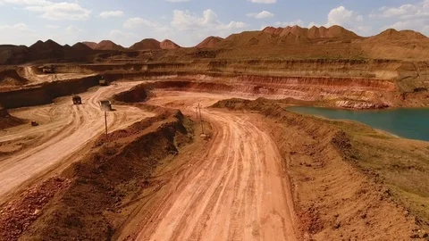 Two dump trucks move in the quarry. Excavators. Ore extraction. Mining. Bouxite Stock Footage 74131775