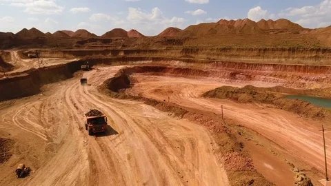 Two dump trucks move in the quarry. Excavators. Ore extraction. Mining. Bouxite Stock Footage 74133148