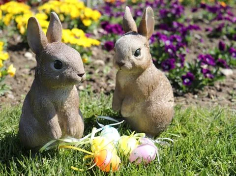 Two Easter bunnies taking care of few eggs Foto stock
