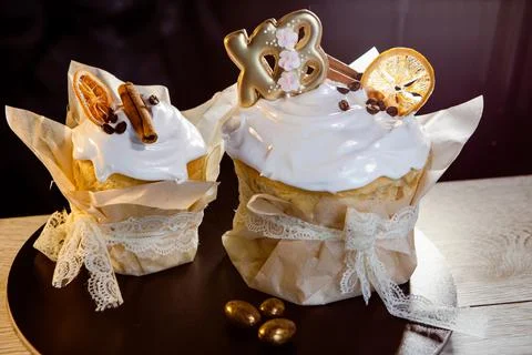 Two Easter cakes decorated with cinnamon and candied fruits Stock Photos