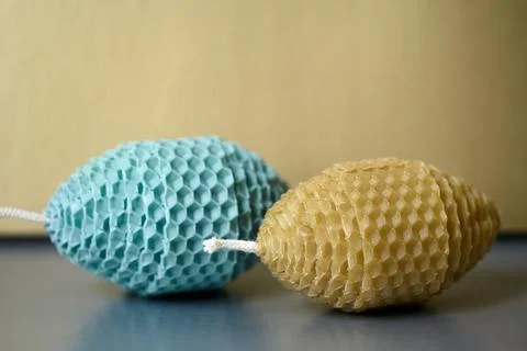 Two Easter Egg Shaped Candles Made of Natural Beeswax on a Neutral Backgrou.. Foto stock