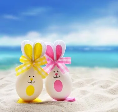 Two Easter eggs with the Bunny ears on the sandy beach Foto stock