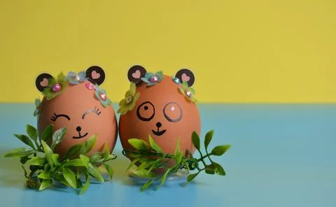 Two Easter eggs close-up on a yellow-blue background. Easter. Stock Photos