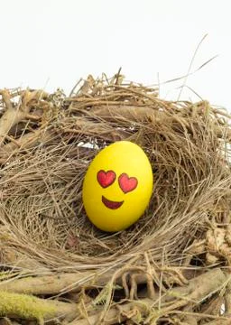 Two Easter eggs painted with emojis, one in love and other kissing, placed in Stock Photos