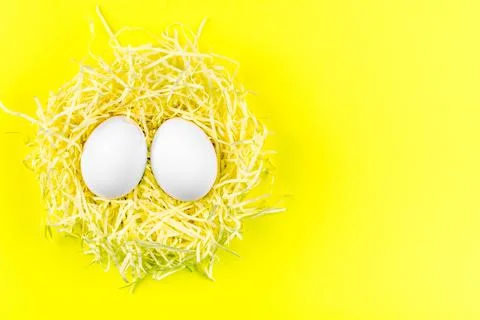 Two Easter eggs on a yellow background.Funny eggs. Postcard with space for te Stock Photos
