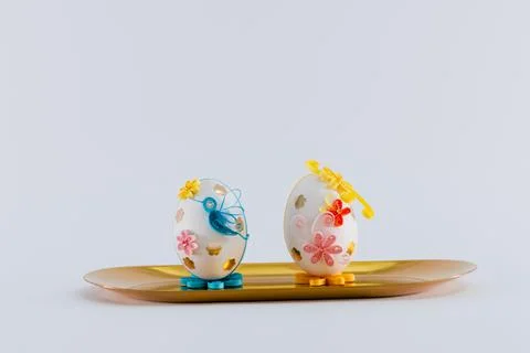 Two Easter eggs on a yellow tray Stock Photos