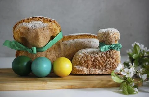 Two Easter lamb cakes with a green ribbon around their necks Stock Photos