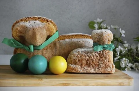 Two Easter lamb cakes with a green ribbon around their necks Stock Photos