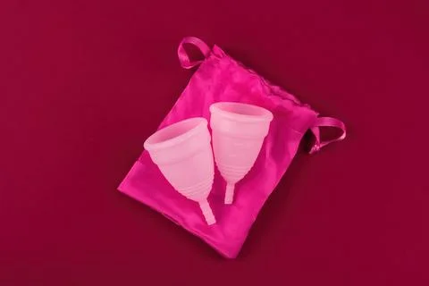Two eco-friendly, reusable pink menstrual cups made of soft medical grade sil Stock Photos