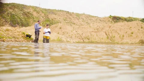 Two ecologists checking with the GPS navigator Video stock 93866867