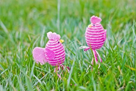 Two egg-shaped chicken standing on the grass Stock Photos