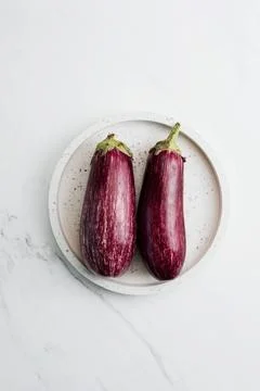 Two Eggplants on a White Plate Stock Photos