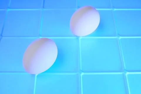 Two eggs on an abstract emerald blue background Stock Photos