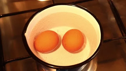 Two eggs are boiled in boiling water. Stock Footage 149819561