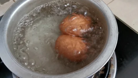 Two eggs boiling in a hot silver pot. Stock Footage 119411599