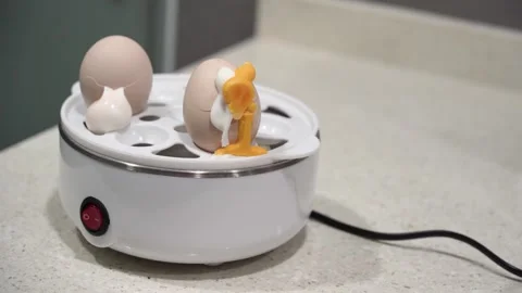 Two eggs cracked and whites and yolks overflow from the shells Video stock 337086421
