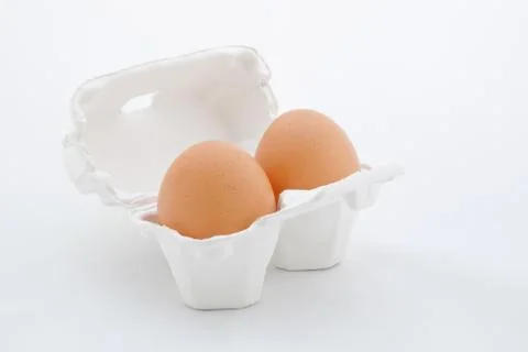 Two eggs in white tray Stock Photos