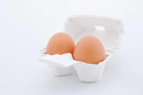 Two eggs in white tray Stock Photos