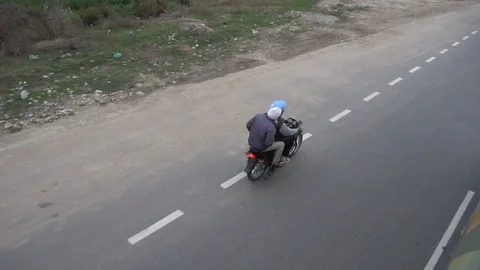 Two Elderly Indian Men With Turbans Riding on Motorcycle on Highway Slow Motion Stock Footage 129586450