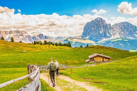 Two elderly men hiking at Seceda peak in the background view of the mountain Stock Photos