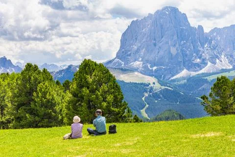 Two elderly people seen at Seceda peak in the background view of the mountain Stock Photos
