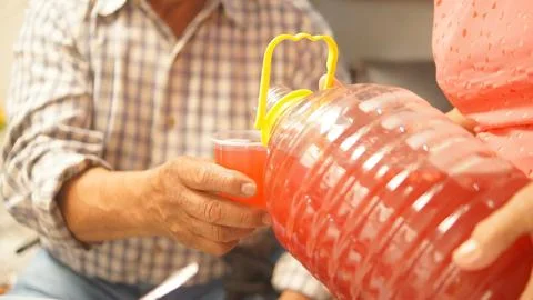 Two elderly people, serving flavored water at a gathering, sharing moments Stock Photos