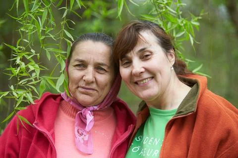 Two elderly sisters in green spring park. Stock Photos