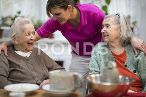 Two elderly women 78 years and 88 years and a carer for the elderly 31 years Stock Photos