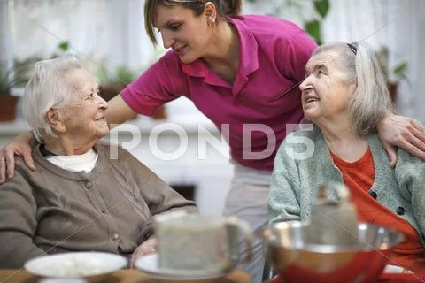 Two elderly women 78 years and 88 years and a carer for the elderly 31 years Stock Photos