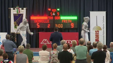 Two elderly women take off helmets at fencing competition Stock Footage 82048355